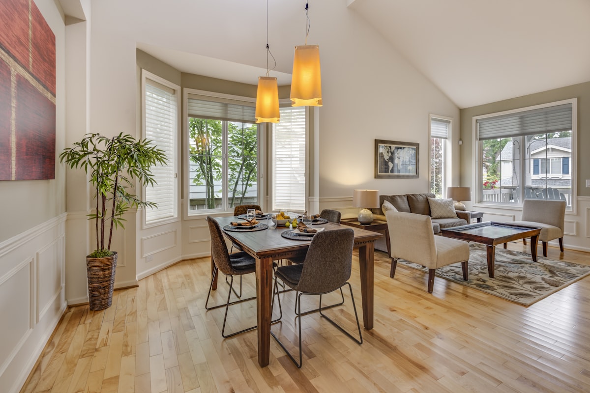 A sunlit dining room with bay windows